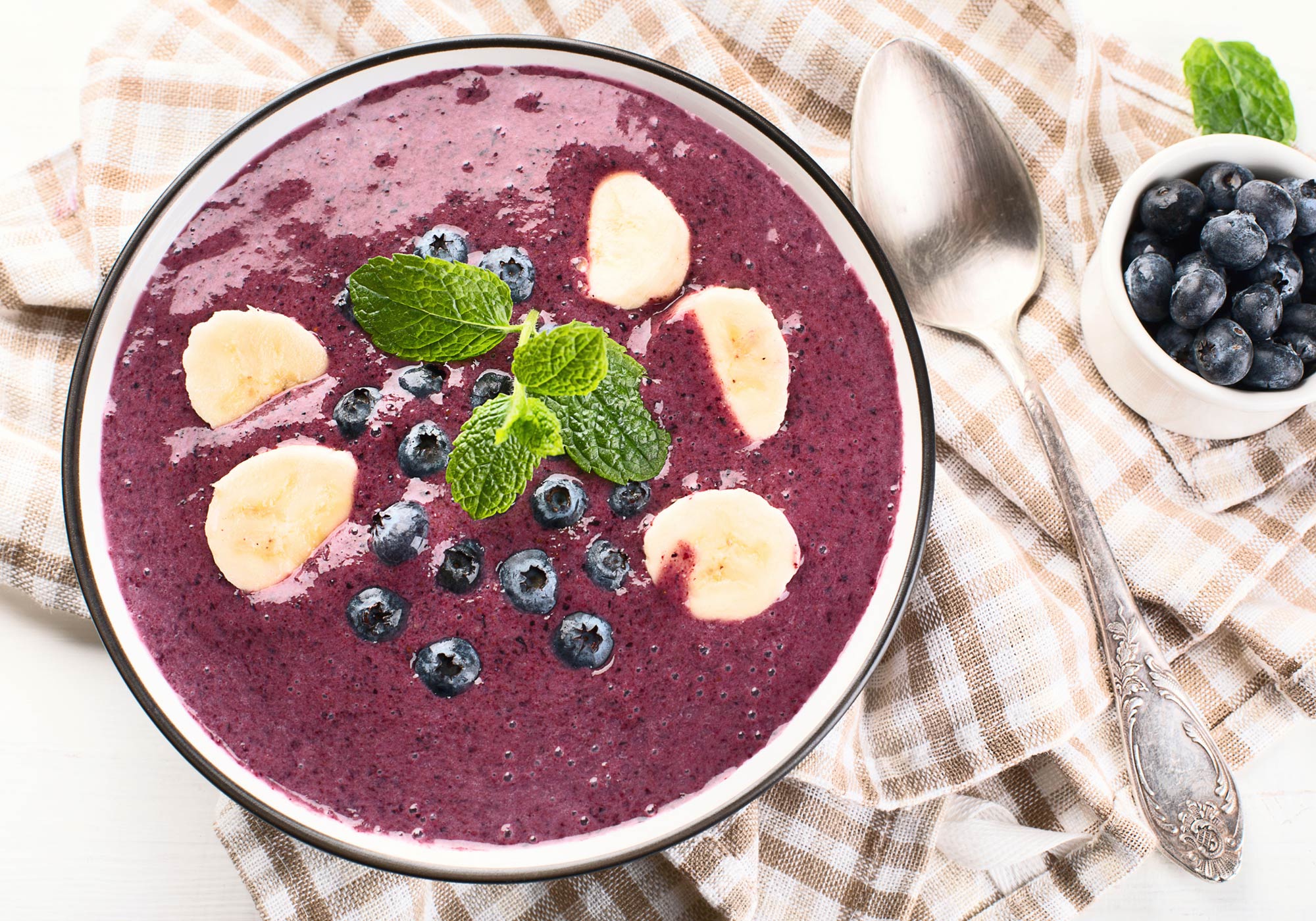 Photo: Blueberry Smoothie Bowl with spoon and small bowl of additional blueberries.