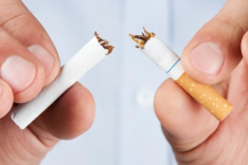 Photo: Man's hands breaking a cigarette in half