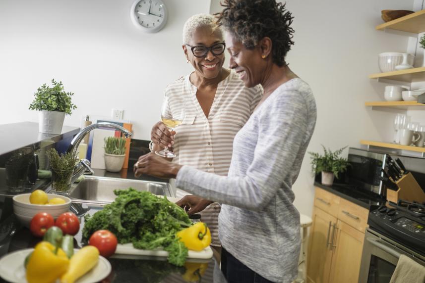 Women in kitchen with Vegetables