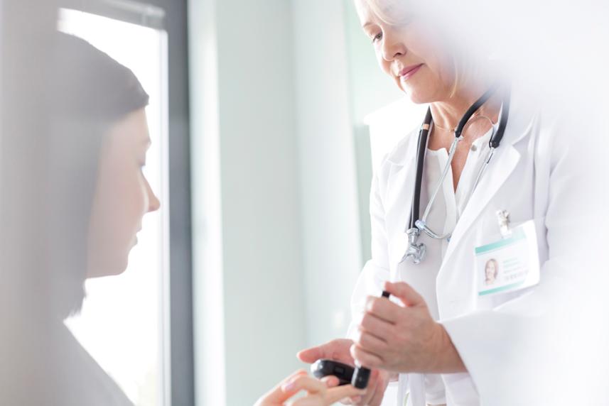 Photo: Doctor reviewing medical information with patient.