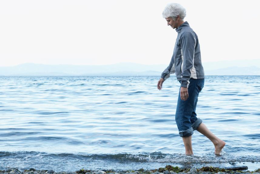 Photo: Woman walking on the beach.