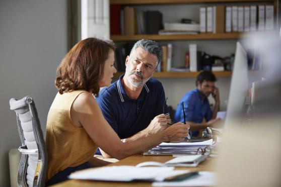 A manager and employee discussion cancer and healthcare issues.