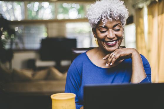 Woman smiling on her laptop