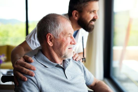 Man looking out window