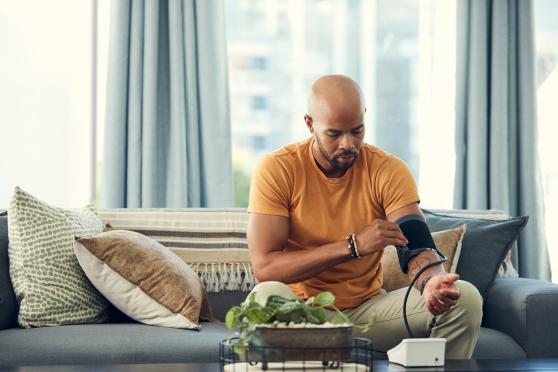 Man checking blood pressure at home