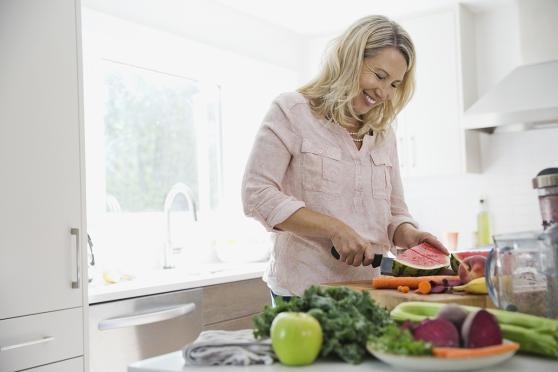 woman cutting up fruits