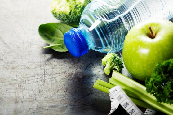 water, apple and lettuce in a group shot