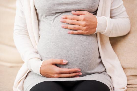 woman holding baby bump