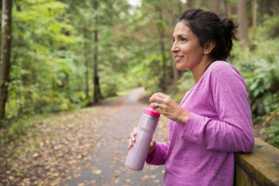 woman in athletic wear about to drink water