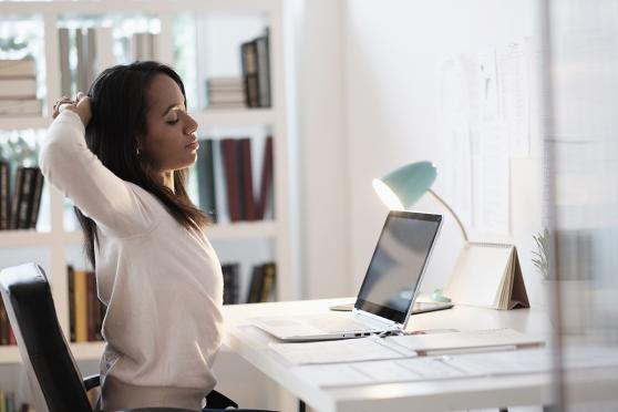 Photo: Happy young woman in bright office setting