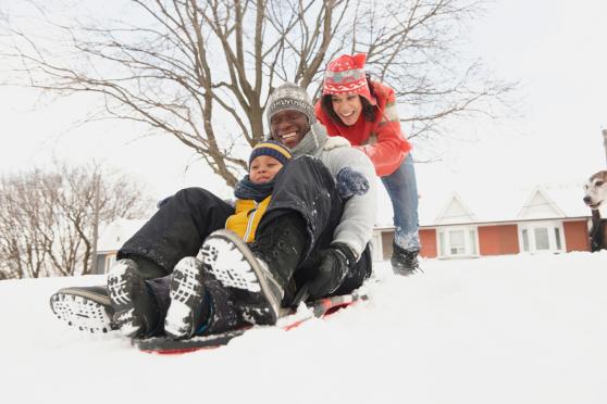 Photo: Happy family playing in the snow in winter