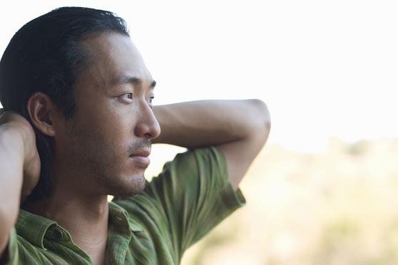 Photo: Man relaxing with arms crossed behind his head