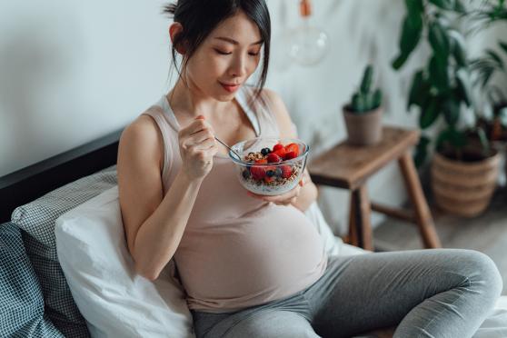 pregnant woman eating yogurt