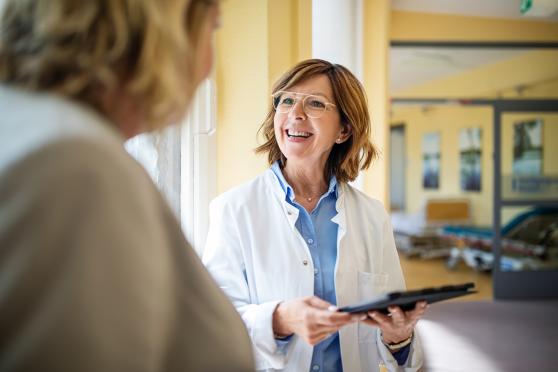 Smiling doctor speaking with patient