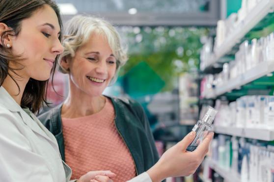 older woman looking at prescriptions