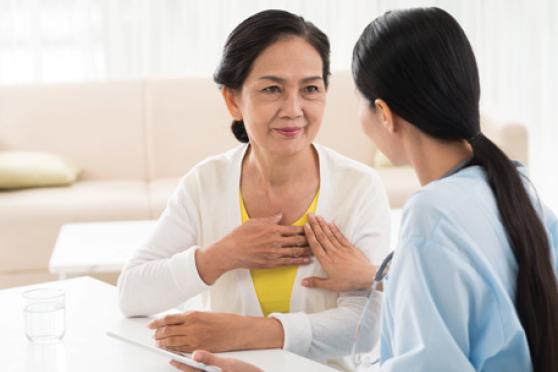 Two women are chatting at a table