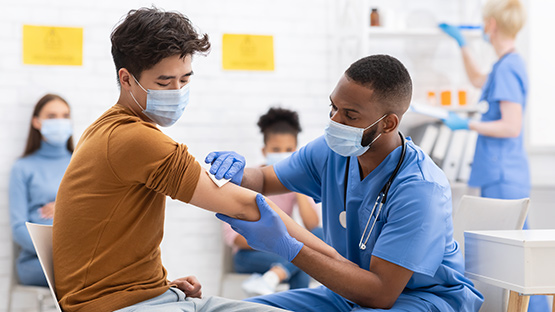 Male Employee Receiving a COVID Vaccine