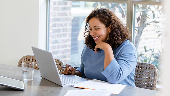 Person on a computer logging in to member portal.